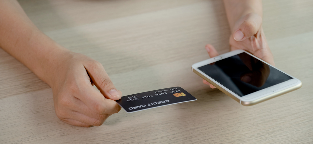 businessman hand hold credit card to online shopping on smartpho